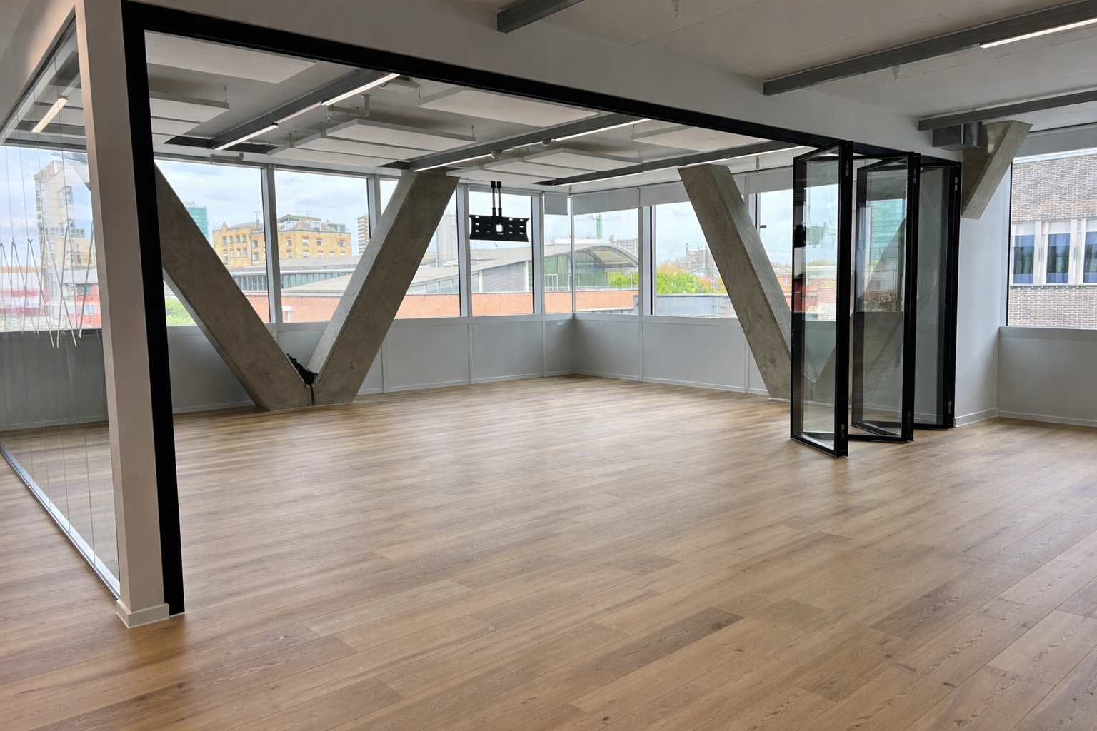 MG500 glazed sliding folding partition closed for acoustic meeting room separation — RW 43 dB performance in commercial office