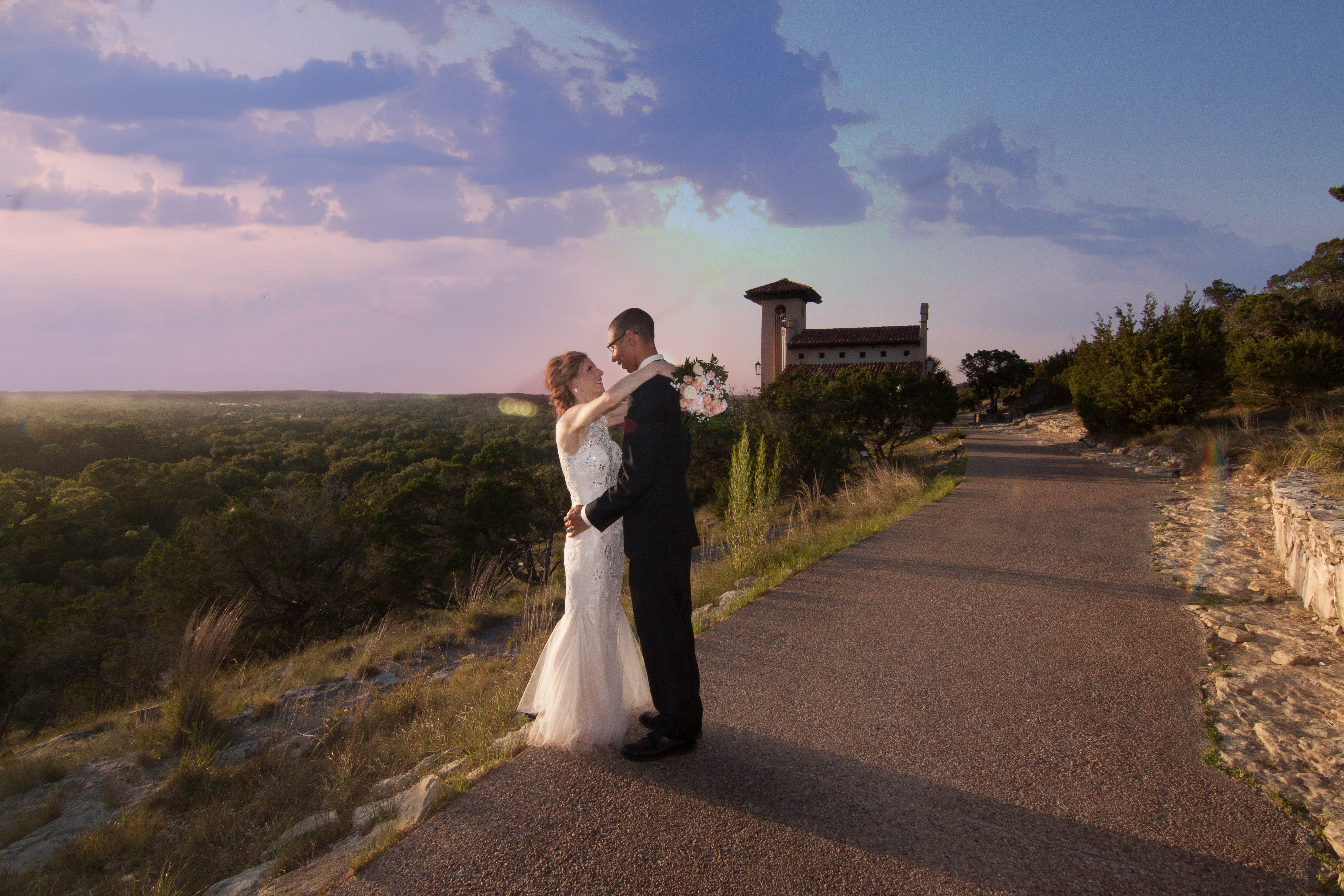 Couple exchanging vows at Chapel Dulcinea with Hill Country panoramic view