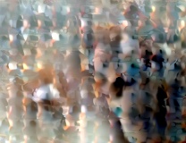 A massage therapy session in progress inside a professional studio with warm wood flooring and neutral beige walls.