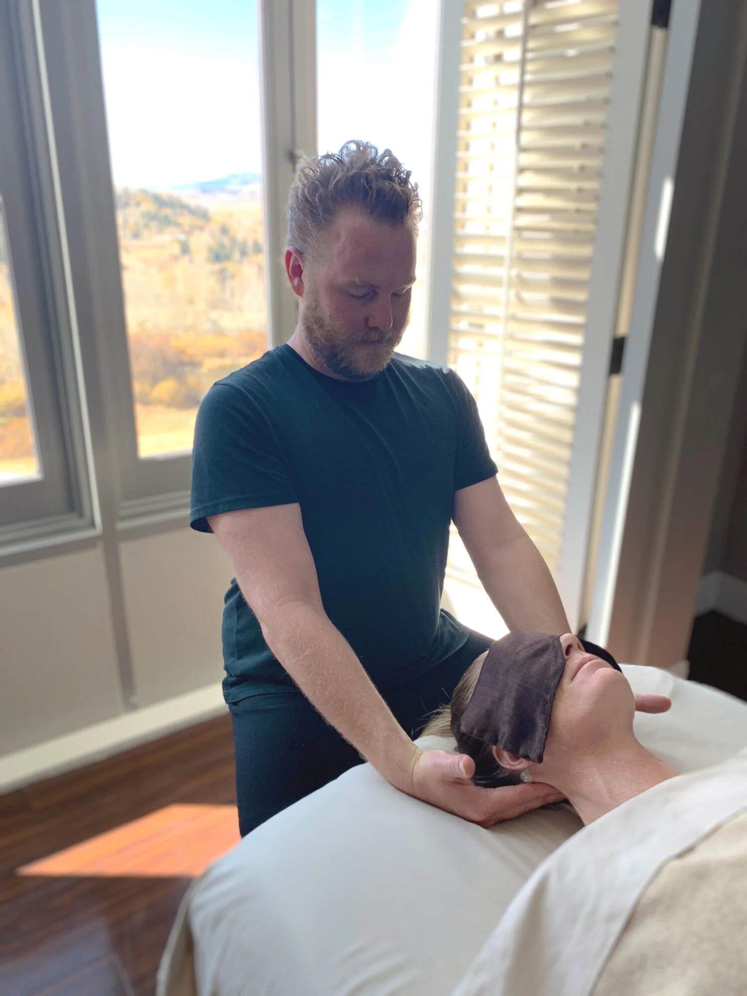 Donavan performing head massage with mountain views